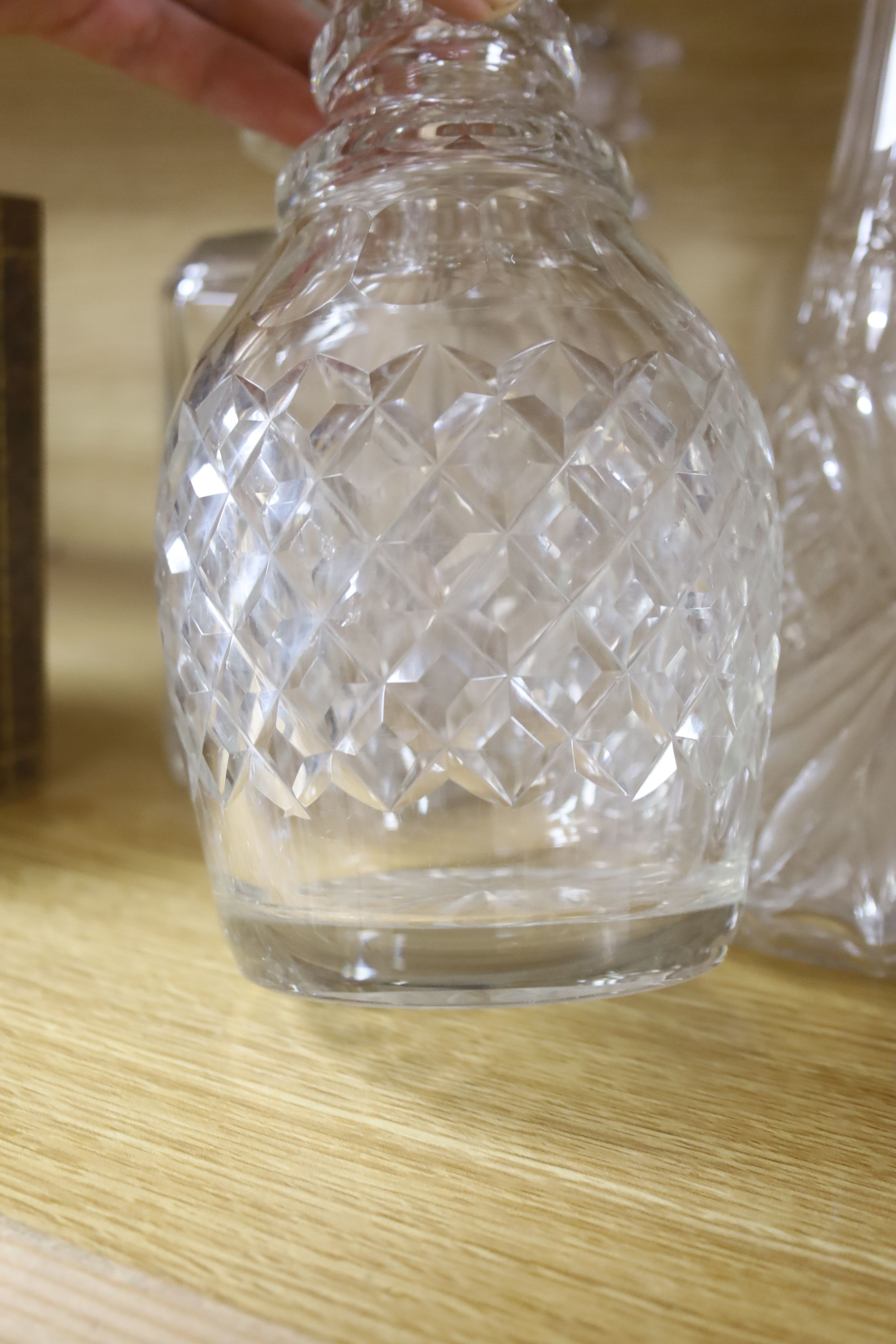 A silver mounted decanter, various other decanters, a claret jug and a jug